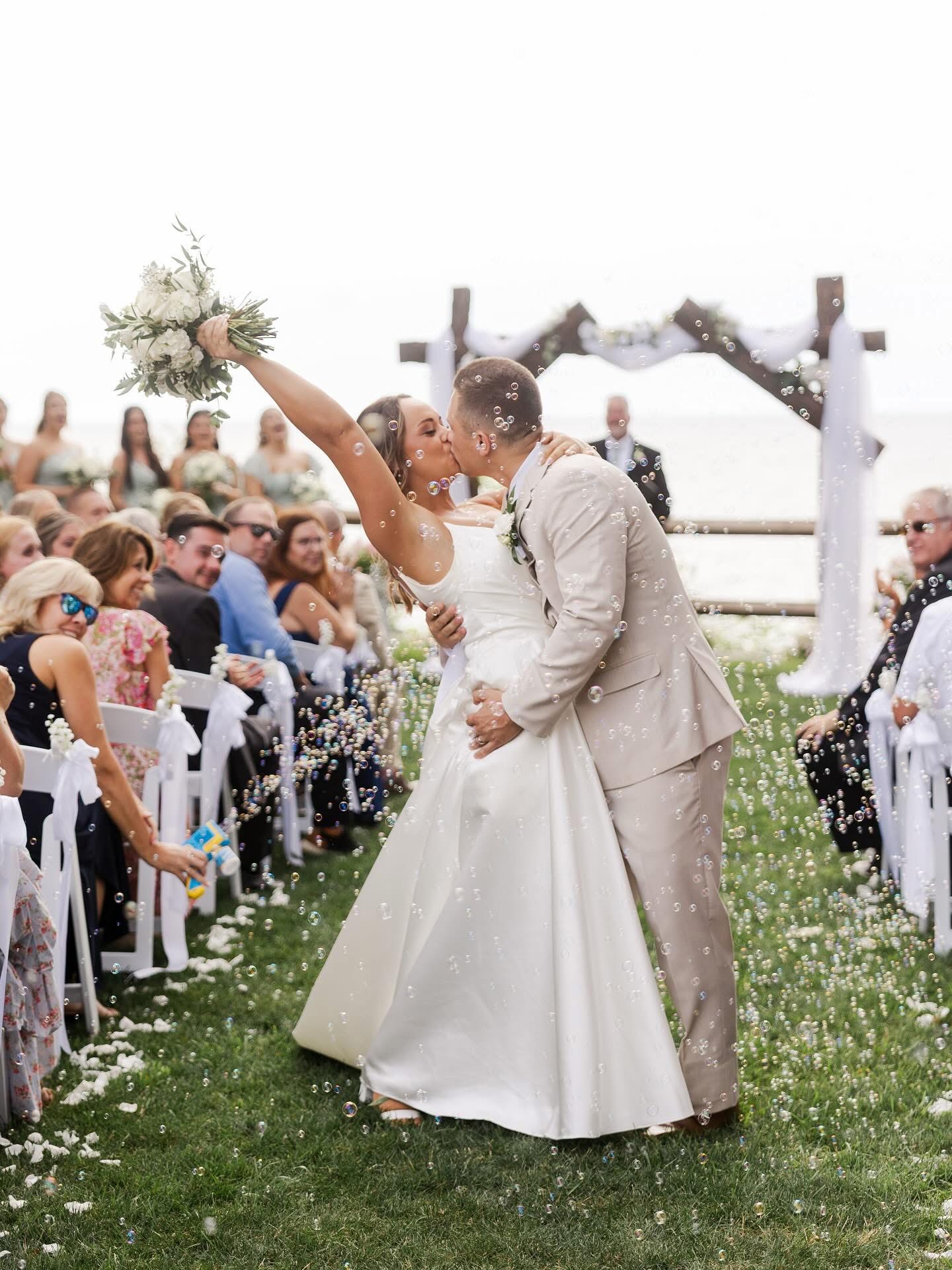 Bride and groom together in a garden, black and white