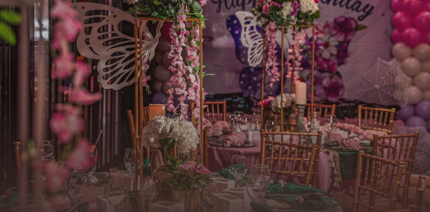 Elegant event table setting with pink florals and balloons